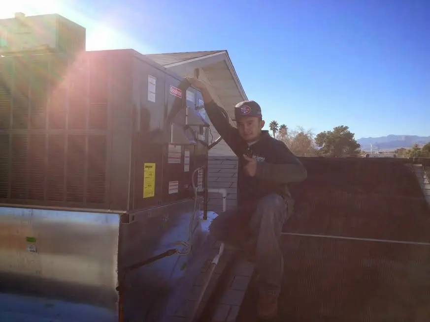 HVAC technician performing HVAC Inspection on a rooftop unit in New Holland